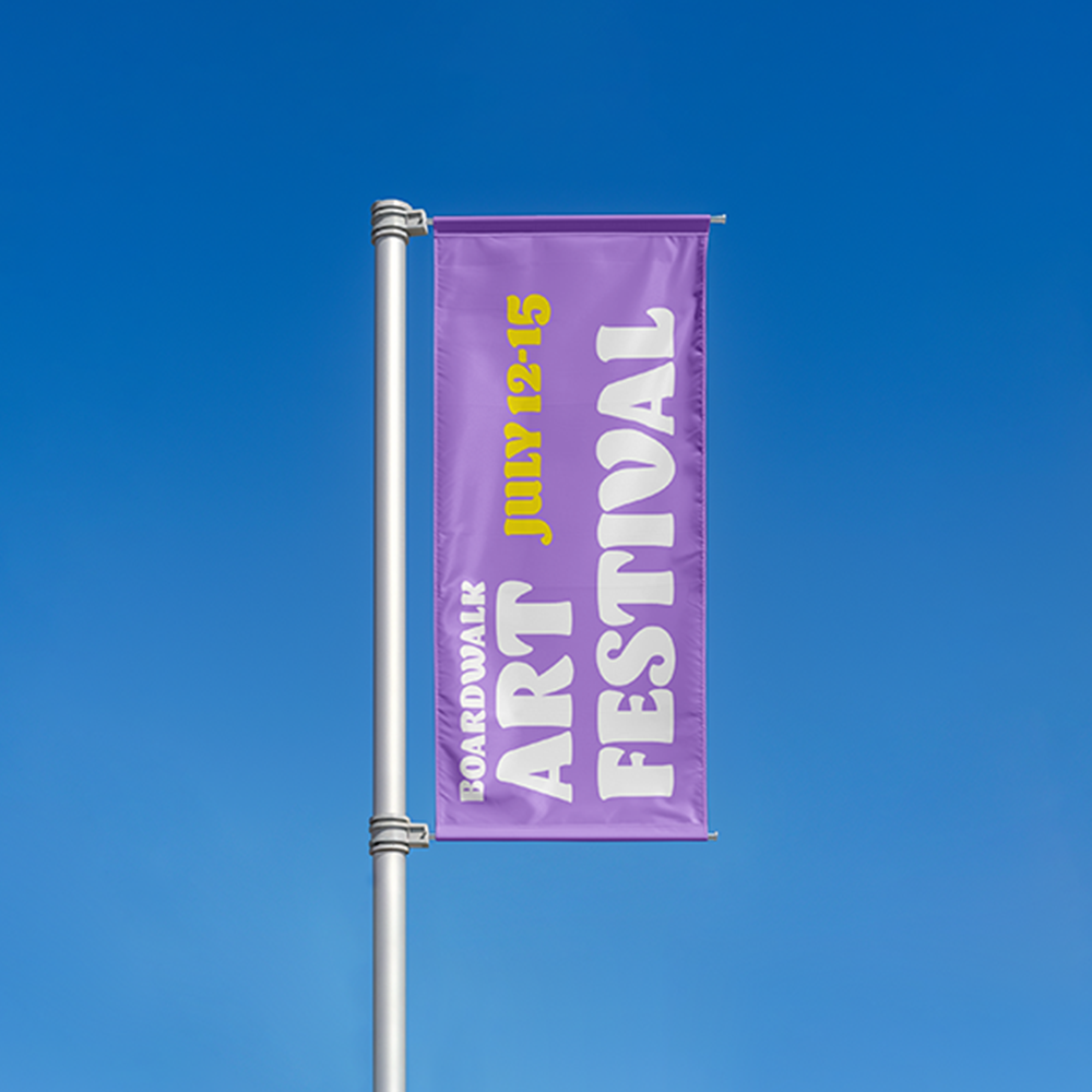 A purple banner on a flag pole advertising an art festival