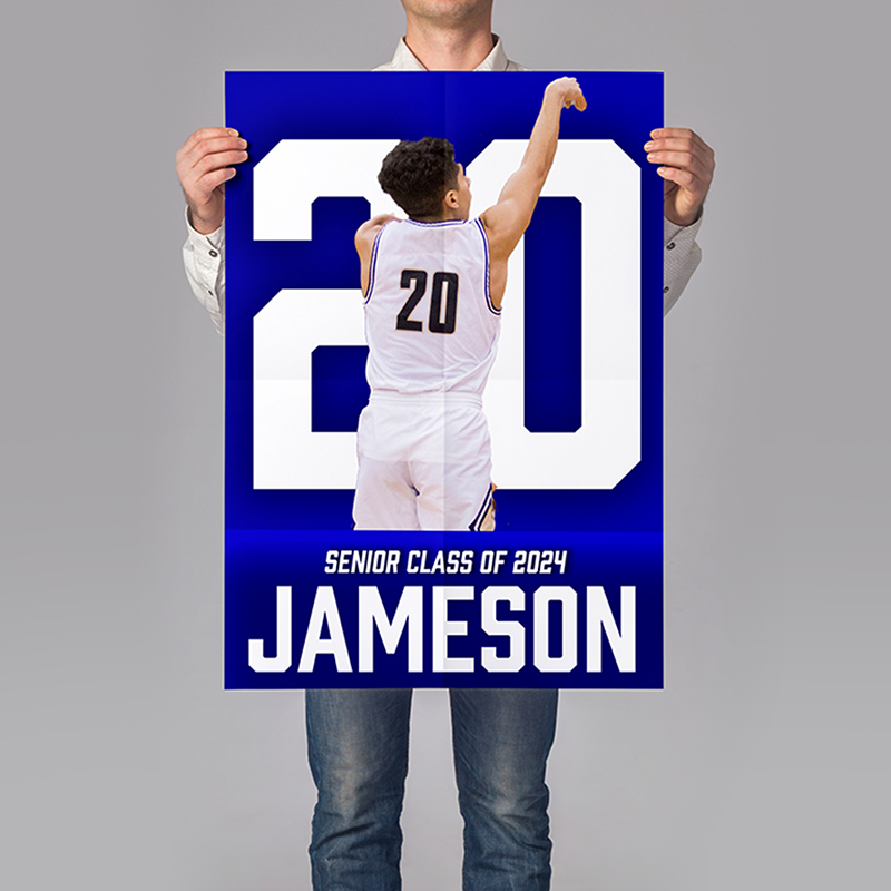 A person holding up a poster featuring a basketball player with his number behind him and the words: senior class of 2024.